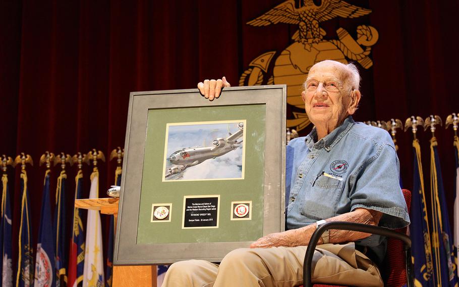 Raymond "Speedy" Biel, a B-29 co-pilot in World War II who participated in both missions to drop the atomic bomb, holds a framed painting of his plane, Full House, Wednesday at Marine Corps Recruit Depot San Diego. The Marines gave Biel the memento to thank him for speaking about his experiences.