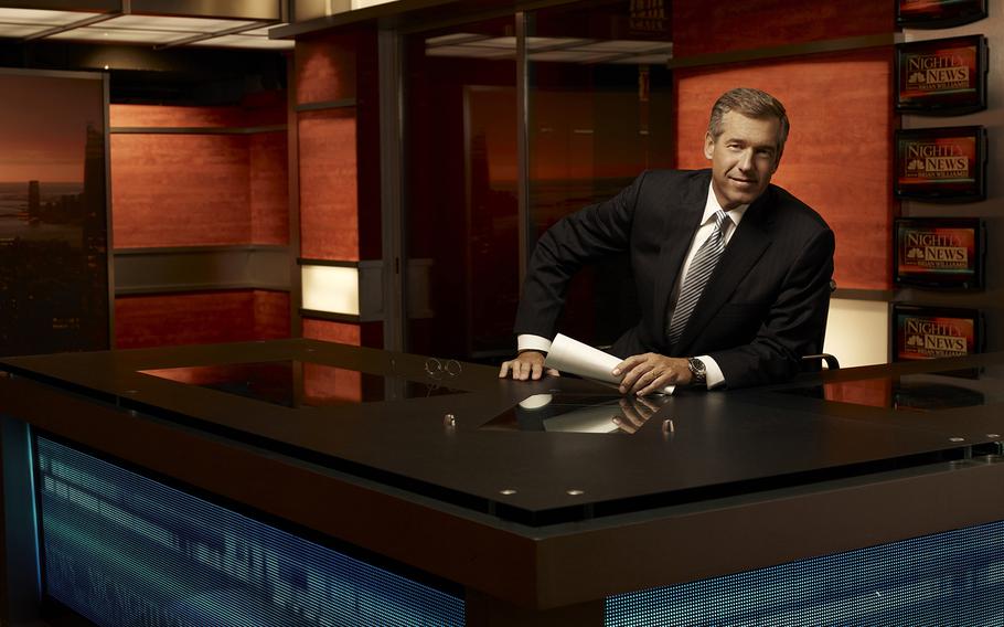 Brian Williams, anchor of "Nightly News" and managing editor at NBC News, sits at his desk.