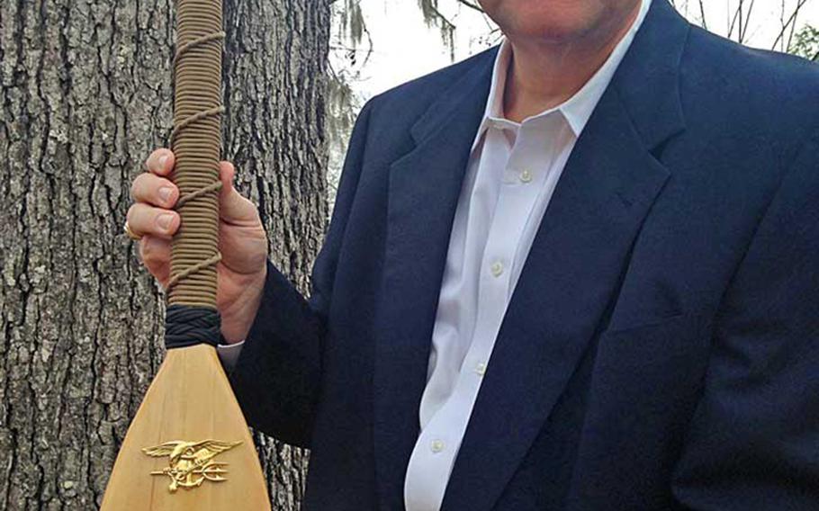 Chaplain Lt. Cmdr. Wesley Modder, shown here holding the ceremonial oar given to him by Naval Special Warfare Command. Modder may be forced out of the Navy for allegedly scolding sailors for homosexuality and premarital sex.