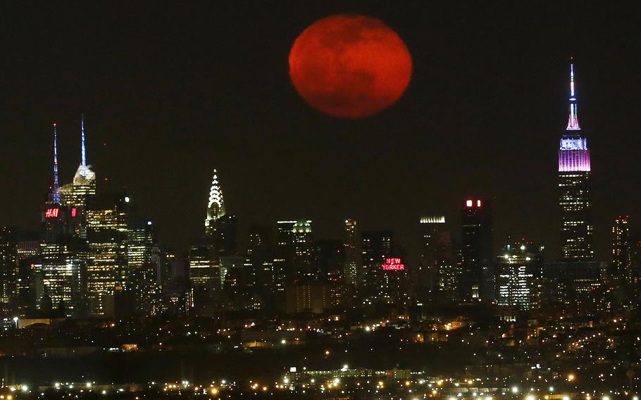 The moon rises in its waning period over the New York City skyline seen from West Orange, N.J., on April 5, 2015.