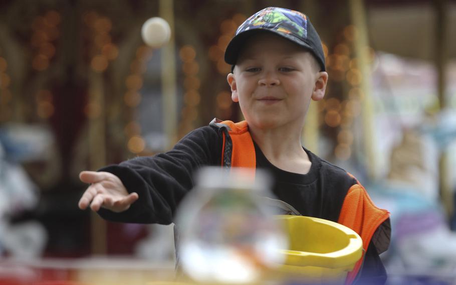 Trenton Havens, 10, tries his luck at the Gold Fish Game at the Midway of Fun carnival at the Mt. Shasta Mall in Redding, Calif., on April 6, 2015. 