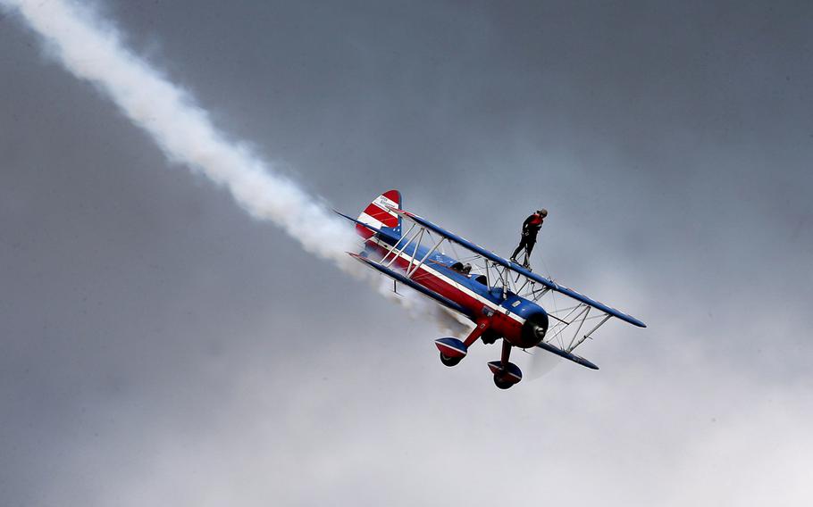 Wing walker Ashley Battles stands atop a biplane during the Gulf Coast Salute Air Show on April 12, 2015 at Tyndall Air Force Base in Panama City, Fla.