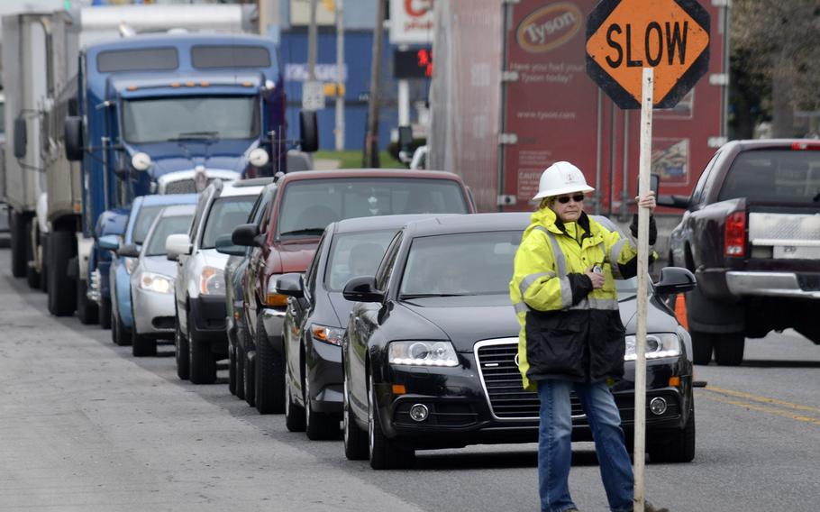 Drivers wait in line for their turn to travel a section of East Main Street restricted to one lane, as road resurfacing work continues on U.S. 35 and Ind. 22 through Gas City, Ind., on April 14, 2015.