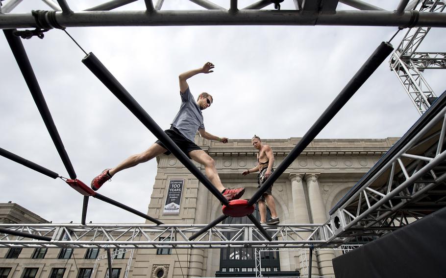 Nate Moore, left, and Kyle DesChamps begin testing the course as construction continued nearby for NBC's American Ninja Warrior on April 14, 2015 in Kansas City, Mo.