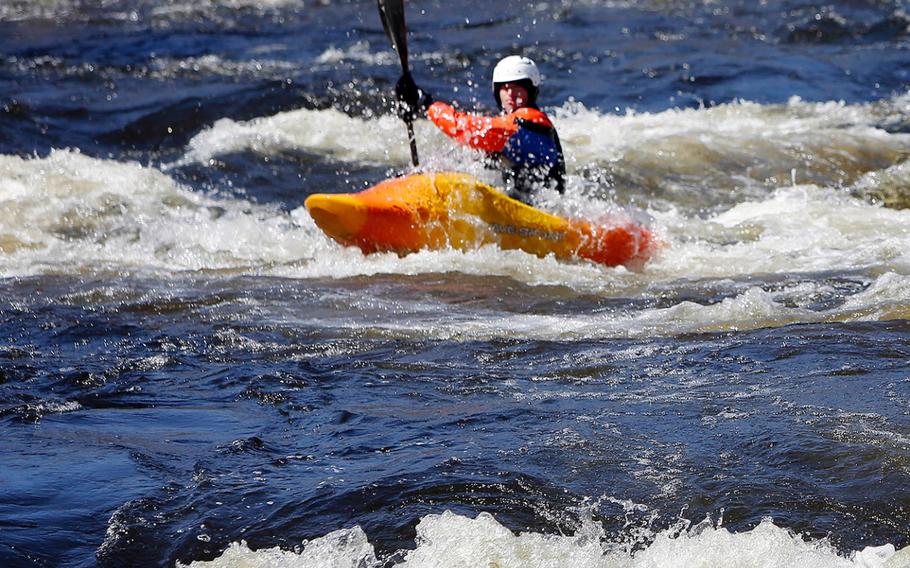 A kayaker maneuvers his way down the snow-melt-swollen Contoocook River on April 12, 2015 in Henniker, N.H.