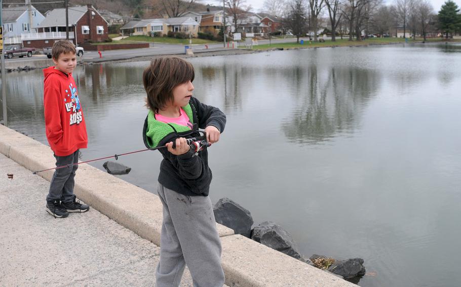 Aiden Roman, left, 9, watches his friend Wyatt Sterner, 10, both of Schuylkill Haven, Pa., cast his line into Stoyer's Dam in Schuylkill Haven, Pa., on April 14, 2015. The boys were fishing for trout that were stocked for the weeklong Scott Shade Trout Rodeo that started on April 11th and runs through the 19th.