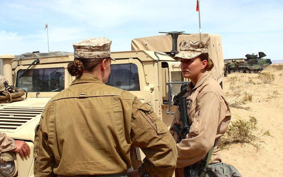 First Lt. Isis Culver, right, talks to Capt. Megan Selbach-Allen during Exercise Desert Scimitar at Marine Corps Air Ground Combat Center Twentynine Palms, Calif. in April 2015. Culver and Selbach-Allen, both communications officers, are 2 of 9 women assigned to 1st Tank Battalion.