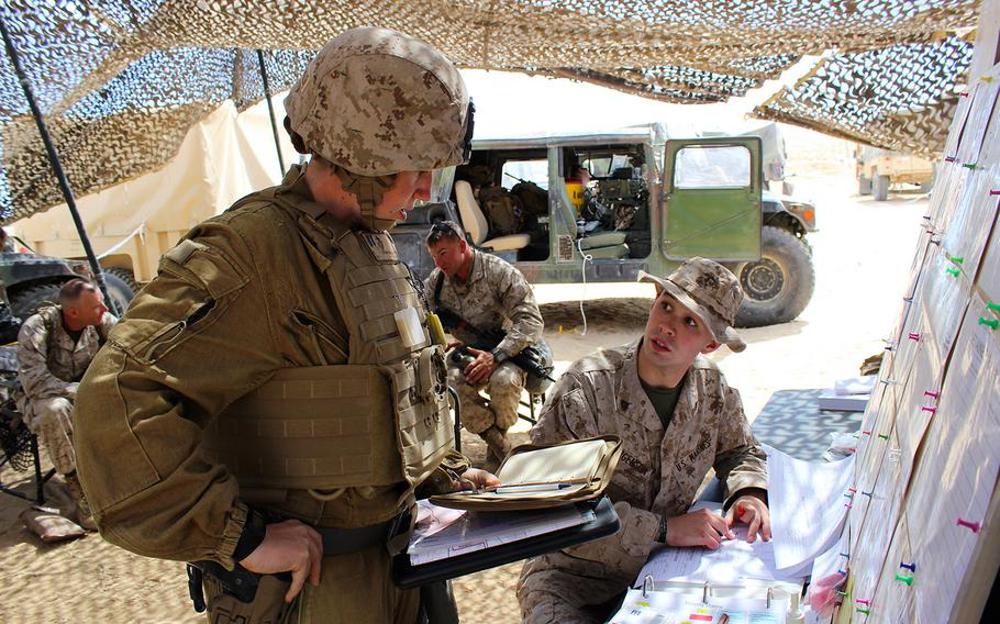 Capt. Megan Selbach-Allen, center, confirms her route with the combat operations center during Exercise Desert Scimitar at Marine Corps Air Ground Combat Center Twentynine Palms, Calif., in April 2015. Selbach-Allen, 1 of 9 women assigned to 1st Tank Battalion, said she loves being a part of 1st Marine Division, which could put her in 'the forward part of the fight.'