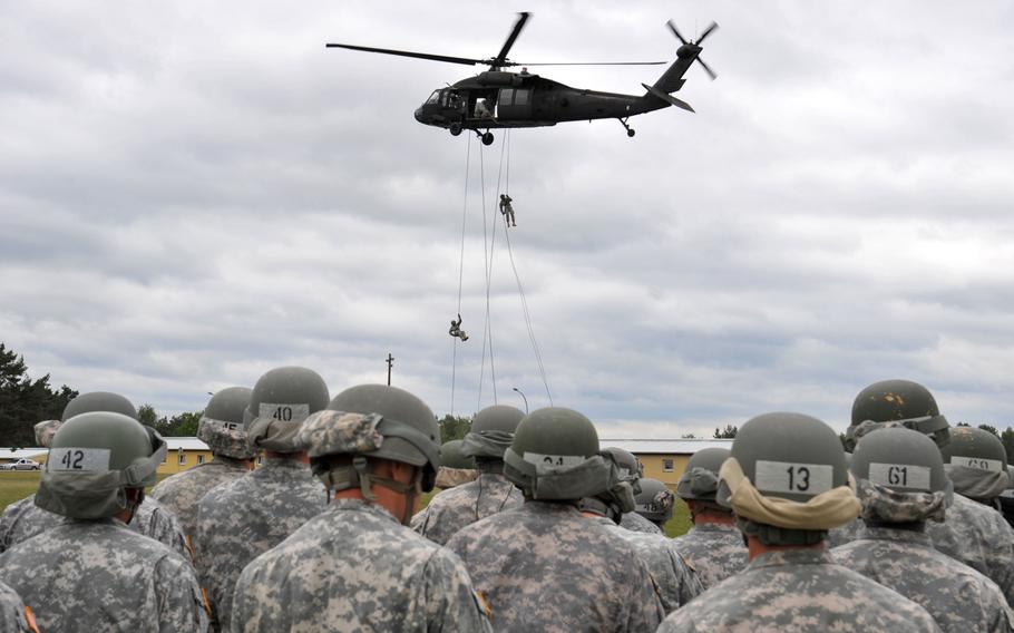 U.S. soldiers rappel from a UH-60 Black Hawk during an air assault course at the 7th Army Joint Multinational Training Command's Grafenwoehr Training Area, Germany, June 9, 2015.