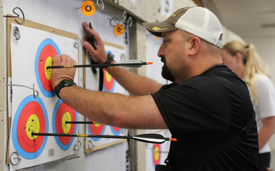 Army veteran Frank Barroqueiro, of Gainesville, Ga., counts up his score during archery training for the 2015 Department Of Defense Warrior Games archery competition at Fort Belvoir, Va., June 9, 2015.