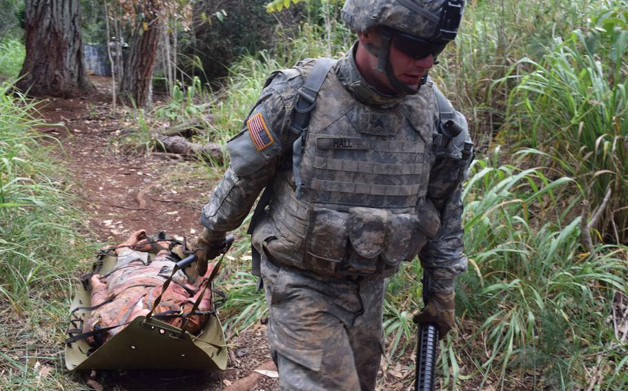 A soldier drags a mock casualty in a test of his first-aid skills while in combat conditions as part of the Best Warrior Challenge on June 9, 2015, during Pacific Army Week in Hawaii.