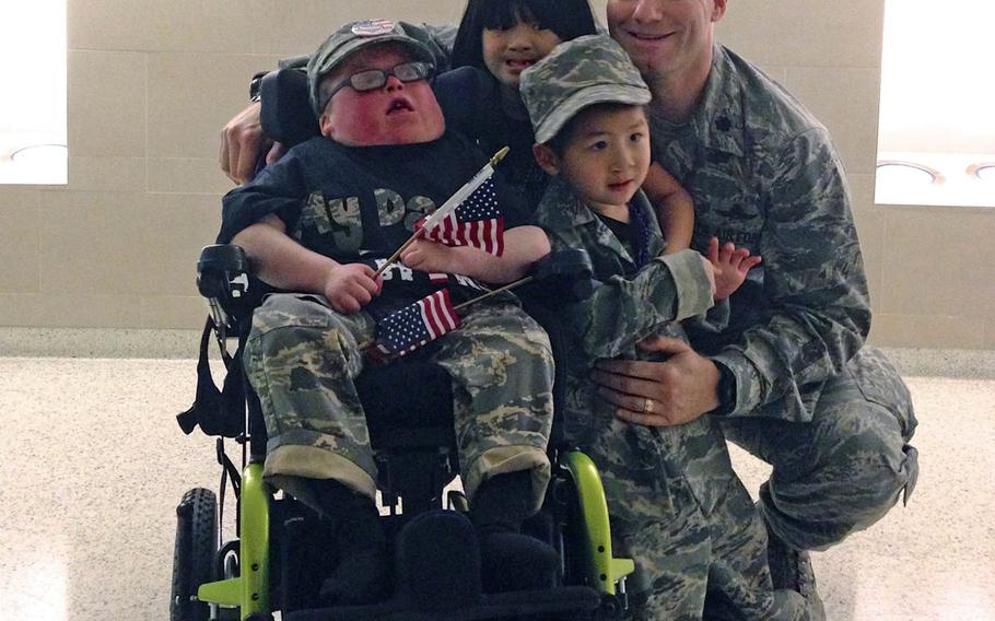 Nathan Tarwater, left, and siblings Addison and Caden, welcome their father Robert Tarwater home from deployment in December 2012. Nathan, who is now 17 and suffers from a rare chromosome disorder that has made him medically fragile, has defied doctors predictions that he would not survive to his first birthday.