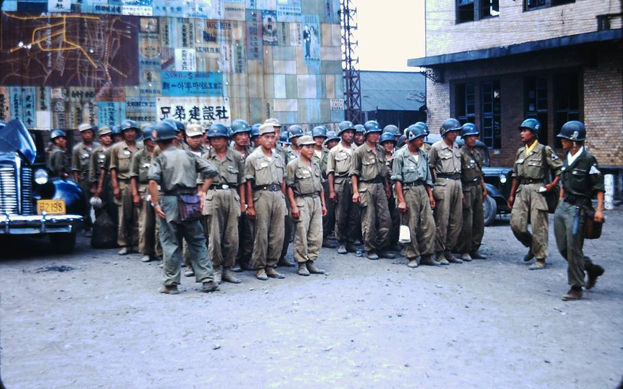 South Korean soldiers stand in formation near the Daejon train station during the Korean War.