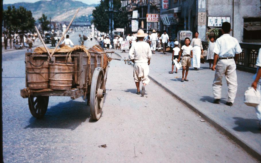 South Koreans walk down a street in Daejon in 1952 during the Korean War.