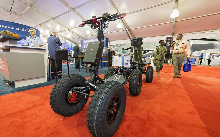 Visitors stroll by a display at the Modern Day Marine Military Exposition at Marine Corps Base Quantico, Va., Sept. 26, 2018. The event is a three-day showcase of the latest in defense manufacturing, science, technology and warfighting products by about 400 exhibitors.