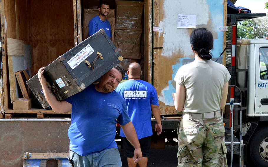 First Lt. Kathryn Bailey, a Black Hawk pilot with the 25th Infantry Division, supervises the delivery and unpacking of her household items on Wheeler Army Airfield, Hawaii, May 11, 2017.