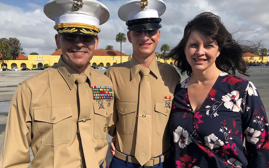 Marine Pvt. Tyler Gilbert, center, poses with his mother, Johanna, and his father, Maj. Lyle Gilbert, after completing recruit training in November in Parris Island, S.C.