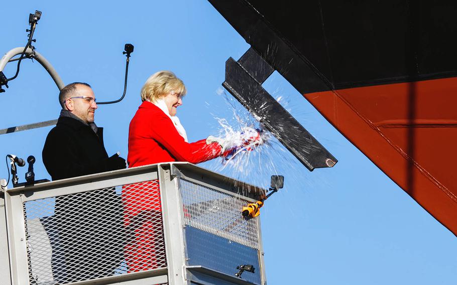 Ship's sponsor Barbara Taylor christens the USS St. Louis in Marinette, Wisc., Dec. 15, 2018.