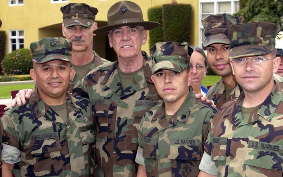 R. Lee Ermey, center, poses with Marines after receiving the honorary rank of gunnery sergeant in 2002.