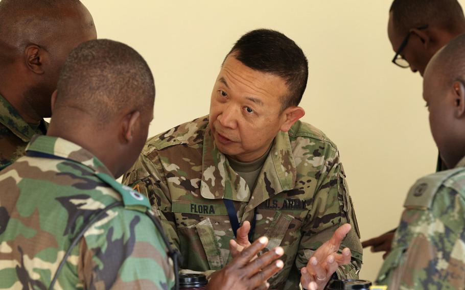 U.S. Army Brig. Gen. Lapthe C. Flora, co-director of Shared Accord 2018, discusses joint operations with officers from various African nations during a break at Shared Accord 2018 in Kigali, Rwanda, Aug. 17, 2018.