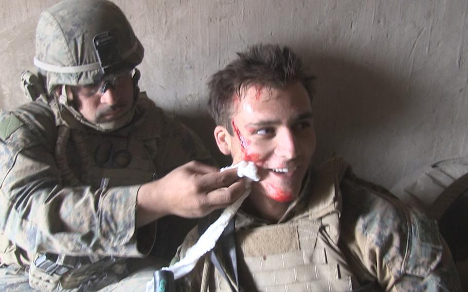 A U.S. Marine receives treatment for shrapnel wounds sustained during a firefight in southern Afghanistan during his 2011-12 deployment.