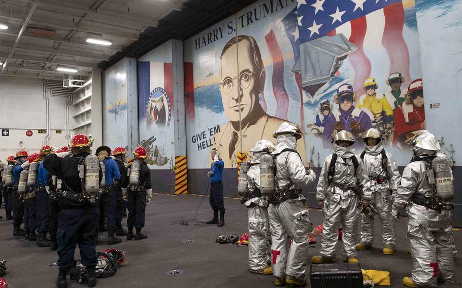 Sailors take part in a general quarters drill in the hangar bay of the aircraft carrier USS Harry S. Truman in the Atlantic Ocean, March 18, 2019.