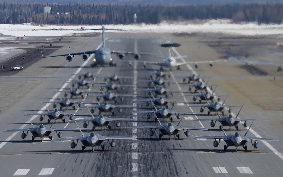 F-22 Raptors participate in an elephant walk with an E-3 Sentry and a C-17 Globemaster III at Joint Base Elmendorf-Richardson, Alaska, Wednesday, March 26, 2019.