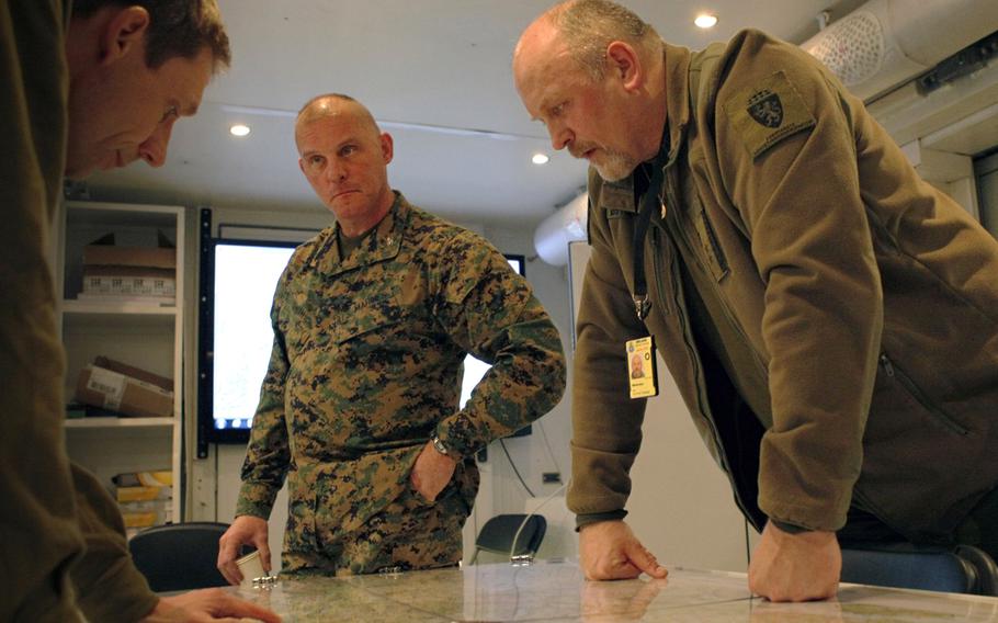 Col. Mark A. Smith, center, deputy commander of 24th Marine Regiment, 4th Marine Division, and Lt. Col. Ole Osteraas, commanding officer of Norwegian Host Nation Support Battalion, look over the area of operations map of Exercise Cold Response 12, in March 2012. Smith, whose prolific letters about his Marines were widely circulated during his command of the Marine Reserves 2nd Battalion, 24th Marine Regiment in Iraq, was buried Wednesday in Indianapolis, Indiana.