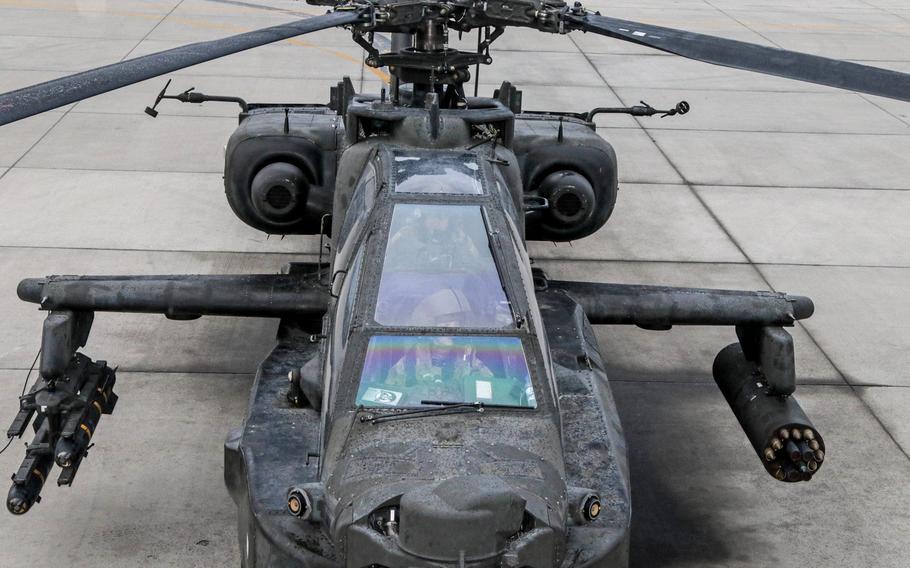 An AH-64 sits ready for take-off as the Apache pilots conduct their final pre-flight inspections inside the aircraft here in Afghanistan. The Army wants to boost flight pay and award pilots with incentive money for career achievements to stem a historic attrition rate in its aviation community.