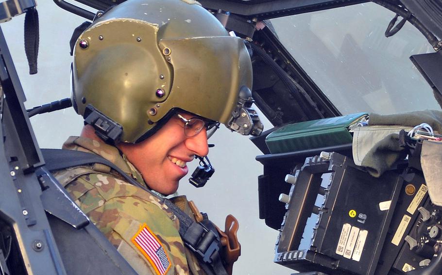 A U.S. Army Apache helicopter pilot assigned to Task Force Viper 1st Battalion, 3rd Aviation Regiment, 12th Combat Aviation Brigade makes final checks before departing Zagan Poland Training Area on June 21, 2018. The Army wants to boost flight pay and award pilots with incentive money for career achievements to stem a historic attrition rate in its aviation community.