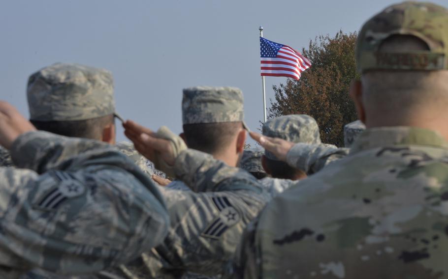 Airmen salute during the national anthem at the opening ceremony of the Clear Sky 2018 exercise at Starokostiantyniv Air Base, Ukraine, Oct. 8, 2018.