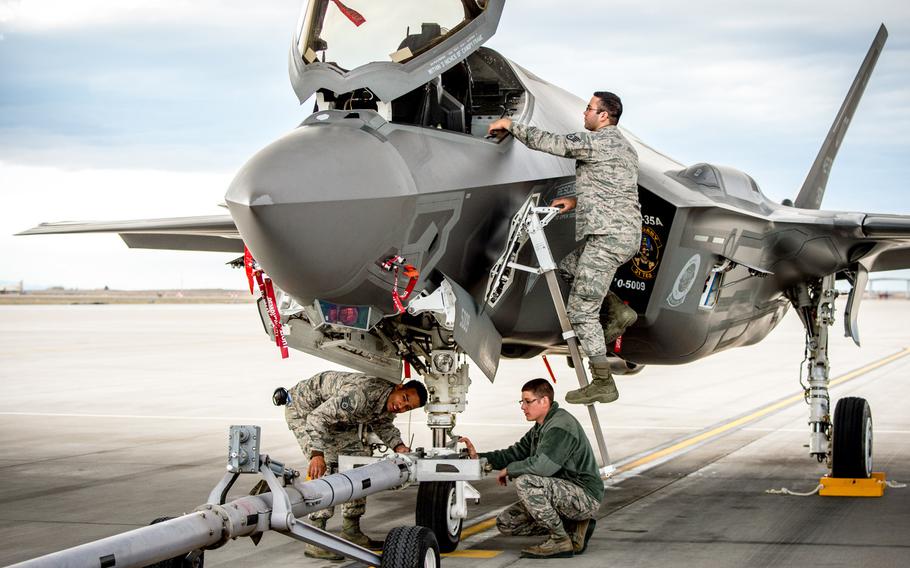Aircraft maintainers Staff Sgt. Thomas Stewart, left, Senior Airman Justin Wilmarth and Staff Sgt. Chris Mauldin, on ladder, prepare to tow an F-35A at Mountain Home Air Force Base, Idaho, in 2016. A shortage of spare parts in the F-35 supply chain has reduced the jet?s mission readiness, a government watchdog has found.