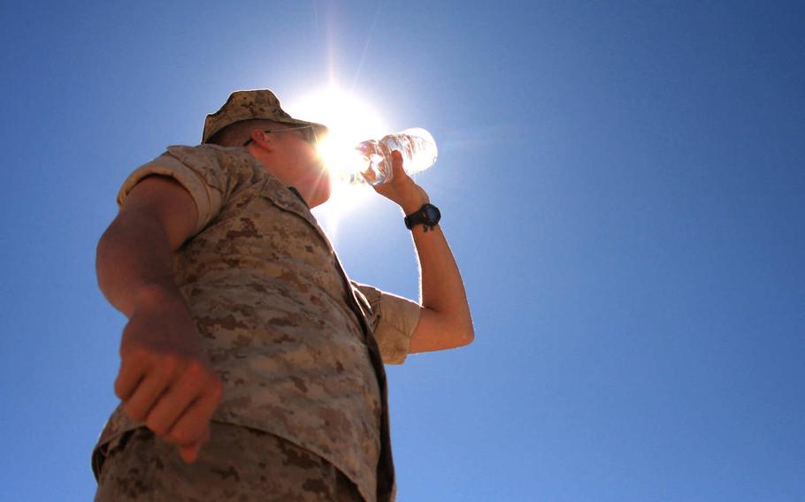 A Marine drinks water at Twentynine Palms, Calif. Heat-related illnesses increased among troops during the past five years, and young Marines and soldiers based in the southeastern U.S. were most at risk, according to a new military medical report.