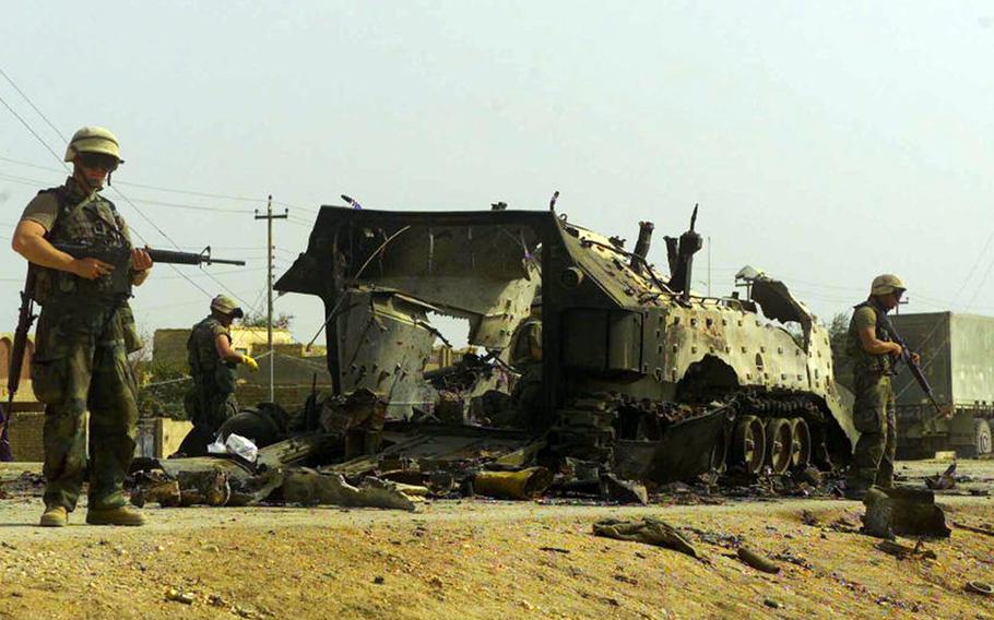 Marines assigned to the Personnel Retrieval and Processing Company recover fallen Marines after an attack on a military vehicle in April 2003 in Nasiriyah, Iraq.