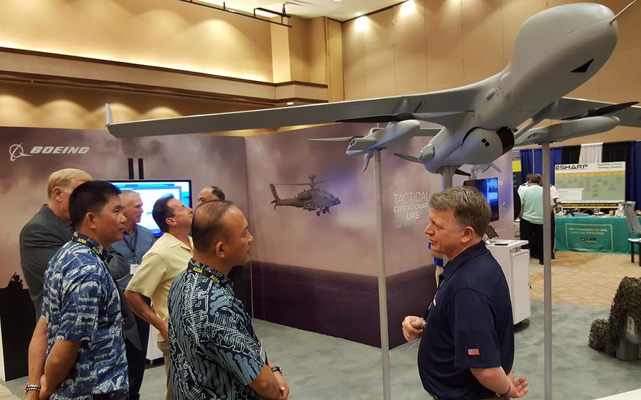 Visitors explore the exhibition hall at the Land Forces Pacific Symposium in Honolulu, Hawaii, Tuesday, May 21, 2019.