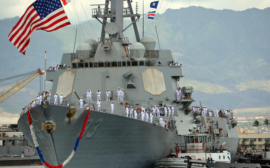 The guided-missile destroyer USS Chung-Hoon is escorted through the harbor before docking at Joint Base Pearl Harbor-Hickama, Hawaii, May 31, 2019.