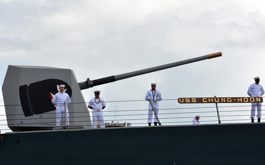 Sailors stand at the rails of USS Chung-Hoon as it arrives at Joint Base Pearl Harbor-Hickam, Hawaii,May 31, 2019, after a seven-month deployment.