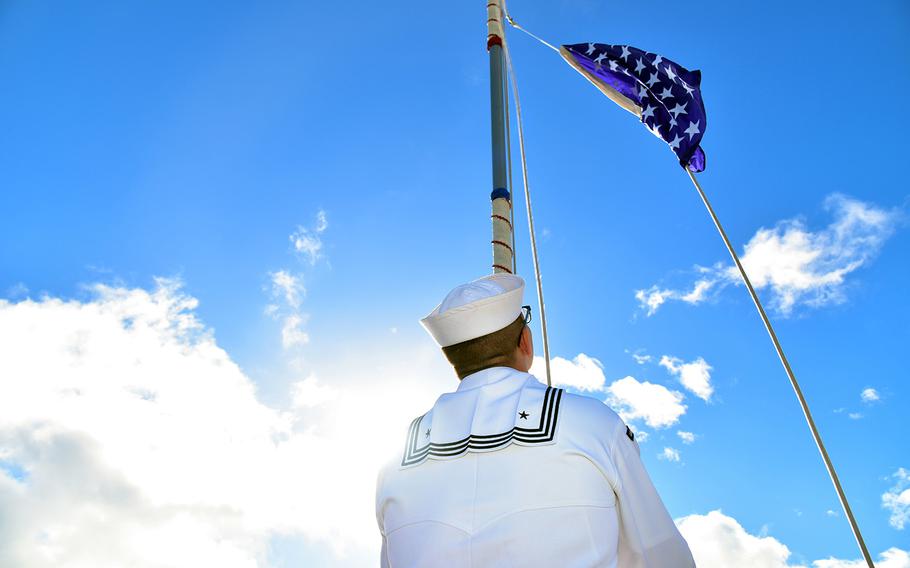 A sailor raises the Union Jack aboard the guided-missile destroyer USS Chung-Hoon during a ceremony at Joint Base Pearl Harbor-Hickam, Hawaii, June 4, 2019.