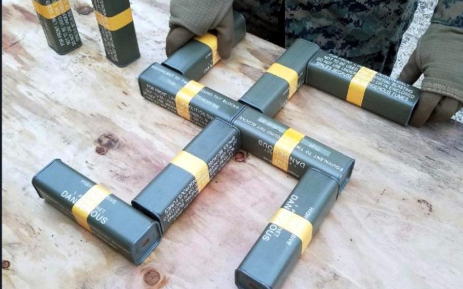 A Marine arranges blocks of TNT into the shape of a swastika in this undated photo posted to Twitter.