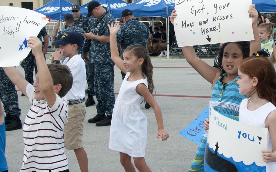 Family and friends await loved ones on the pier during a homecoming celebration for the attack submarine USS Oklahoma City at Apra harbor, Guam, in December 2016. Two recent studies differ on whether men on submarines father girls significantly more often than they do boys.