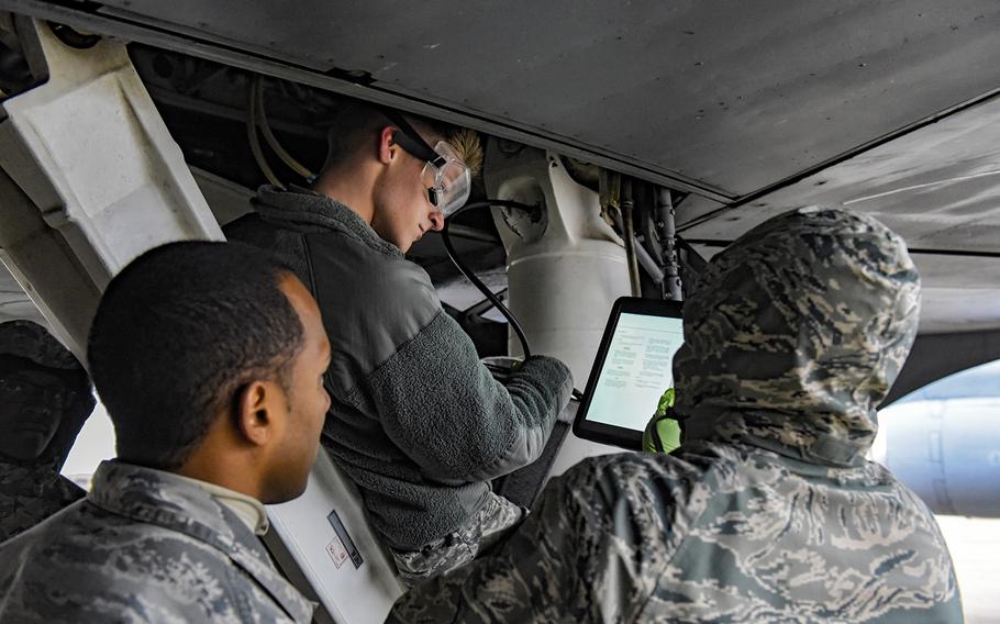 Air Force instructor Tech. Sgt. Brandon Garcia, left, watches airmen Jacob Blann, center, and Michael Aytiah as they learn to service a KC-135 Stratolifter at Sheppard Air Force Base, Texas, Dec. 13, 2018. 