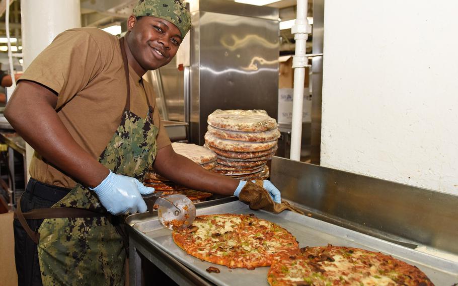 Seaman Daquan Horne, from Charlotte, N.C. cuts pizzas in the aft galley aboard the aircraft carrier USS Theodore Roosevelt, in the Pacific Ocean, Feb. 24, 2019. U.S. Special Operations Command has denied a recent report that said there were plans to ban foods like pizza and mandate a low-carbohydrate, ketogenic diet for servicemembers.