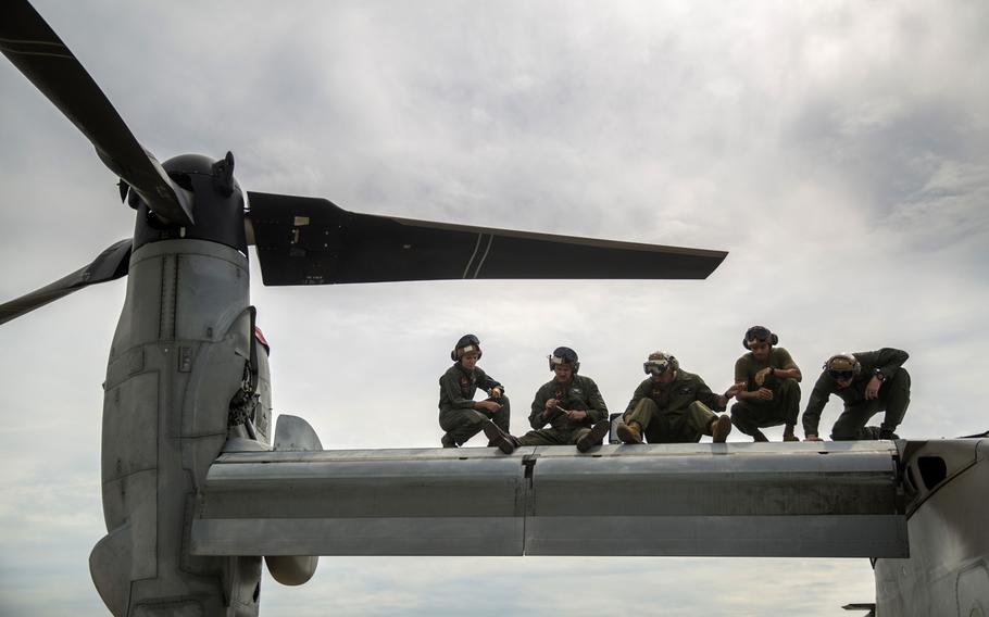 U.S. Marines conduct maintenance on an MV-22 Osprey tilt-rotor aircraft in Darwin, Australia, May 9, 2019. The Corps is offering retention bonuses in certain career fields for fiscal year 2020, including aviation maintenance.