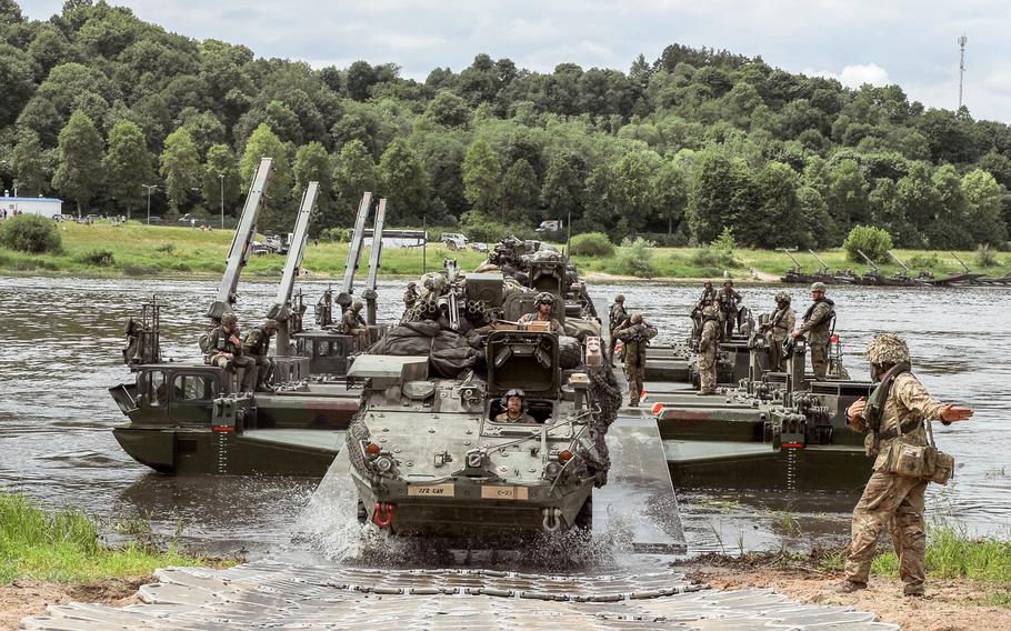 With the assistance of a German engineer battalion, Strykers from the 2nd Squadron, 2nd Cavalry Regiment complete a contested wet-gap crossing near Kaunas, Lithuania, during training in June 2018. A defense bill passed by lawmakers wants the Pentagon to examine how to better reinforce the Baltics with more air defenses, troop rotations and other measures aimed at countering Russia. 