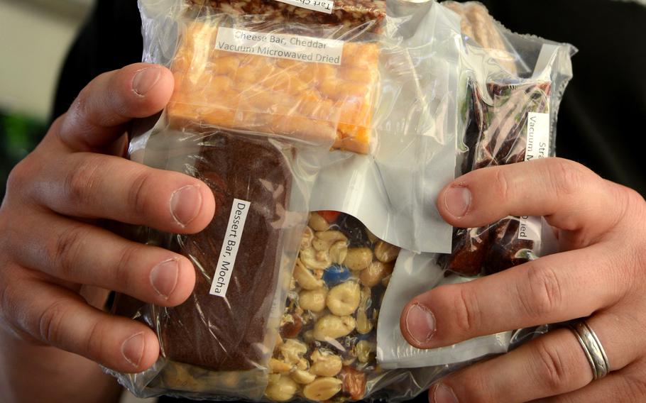 The Army is developing a new ration that uses vacuum-microwave technology to shrink items. Items under development from the Close Combat Assault Ration at the Pentagon May 24, 2018 include a root vegetable bar, Korean barbeque stir-fry package, spinach quiche, cheddar cheese bar, banana and French toast.