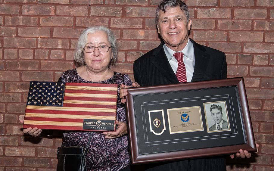 Joyce Bailey, left, and David Algranti, niece and nephew of Purple Heart recipient Army Air Corps Pfc. John Epstis, recieve their uncle's Purple Heart during a ceremony at the New York City Fire Museum in Manhattan, Aug. 7, 2019.