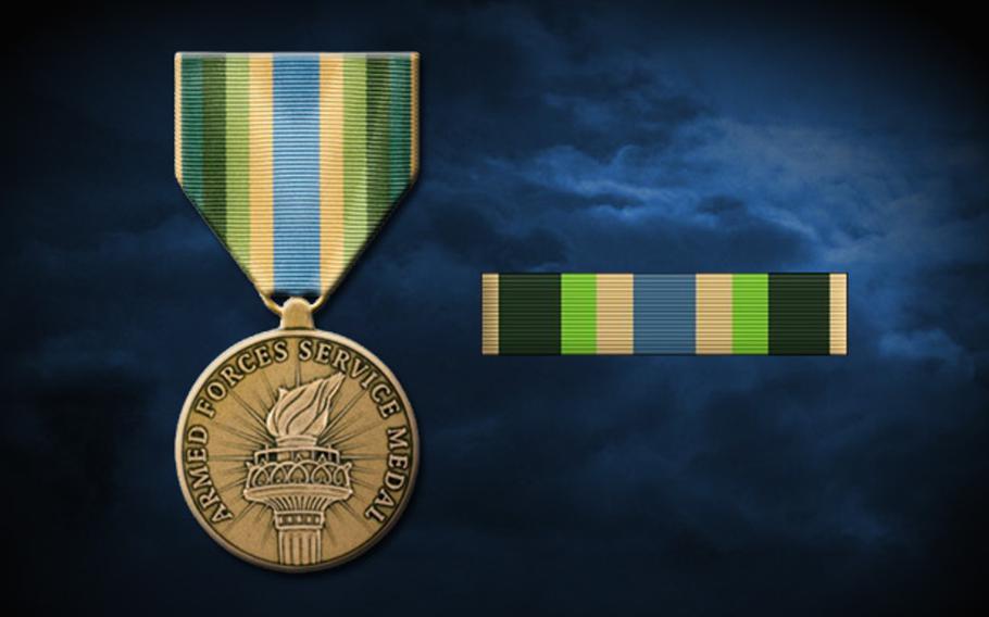 The Armed Forces Service Medal has a green, blue and yellow ribbon attached to a bronze medal featuring a Statue of Liberty style torch. Troops who served along the Mexican border since last spring have been authorized to receive the medal.