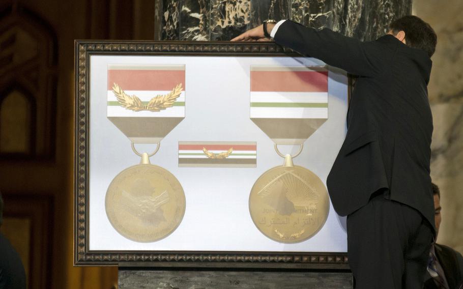 The Iraq Commitment Medal is unveiled during a ceremony in Baghdad on Dec. 1, 2011.