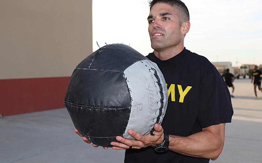 Maj. Timothy Cox throws medicine balls during a morning physical training session at Fort Bliss, Texas, as he practices for the Army Combat Fitness Test. Cox set a new standard by obtaining a 600, the highest score ever recorded, on the Army Combat Fitness Test.