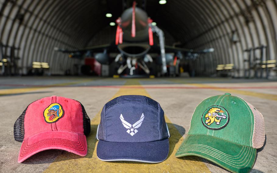 Two squadron bump caps are displayed alongside a prototype Air Force bump cap at Osan Air Base, South Korea, Wednesday, Aug. 28, 2019.